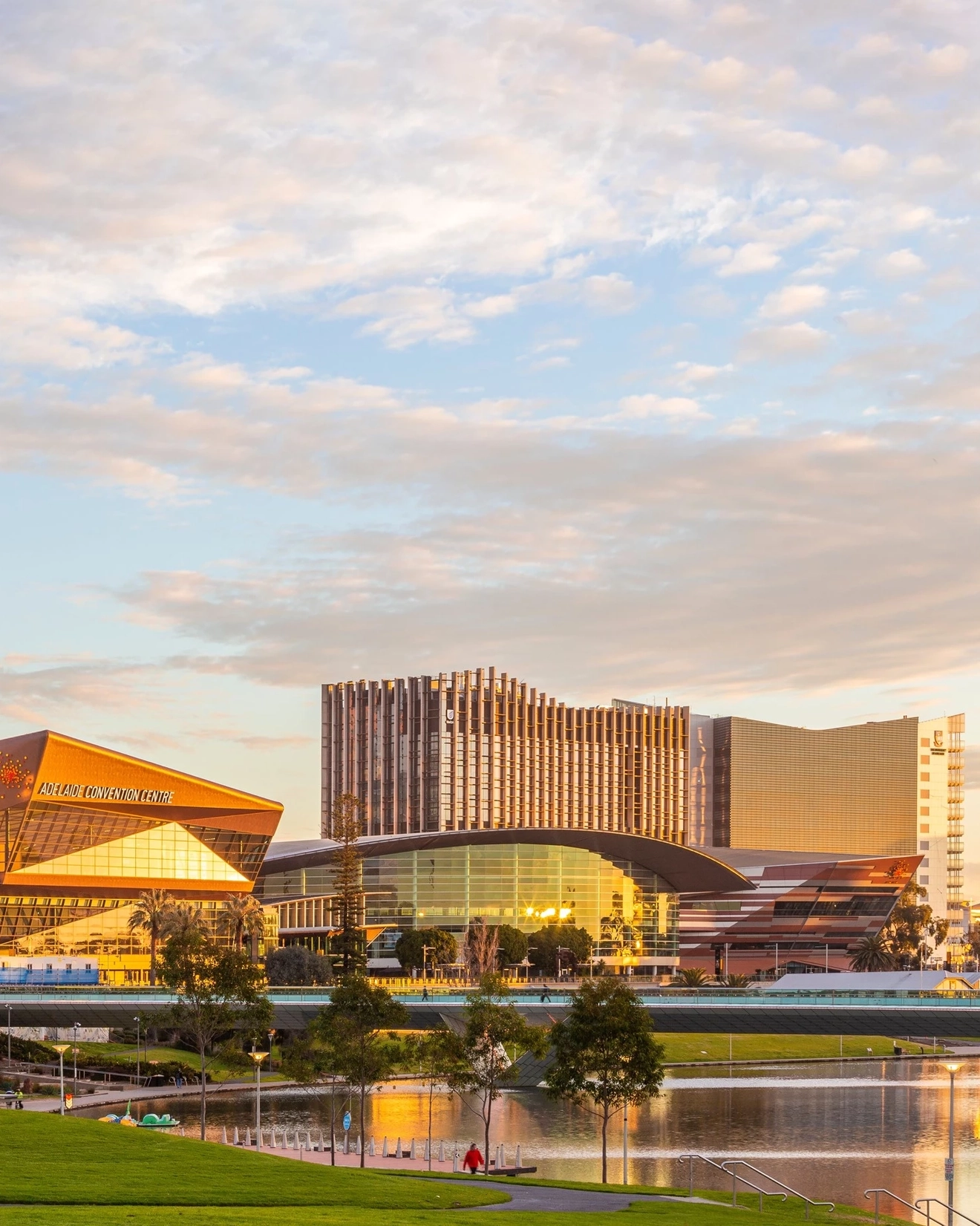 Exterior view of Adelaide's Riverbank Precinct with rotunda in foreground, River Torrens and city skyline in background.