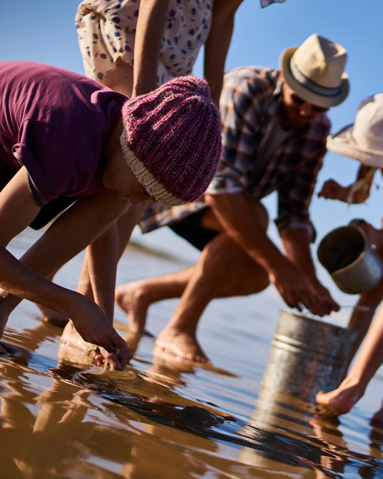 Family collecting cockles at Goolwa Beach, South Australia. Image credit: SATC