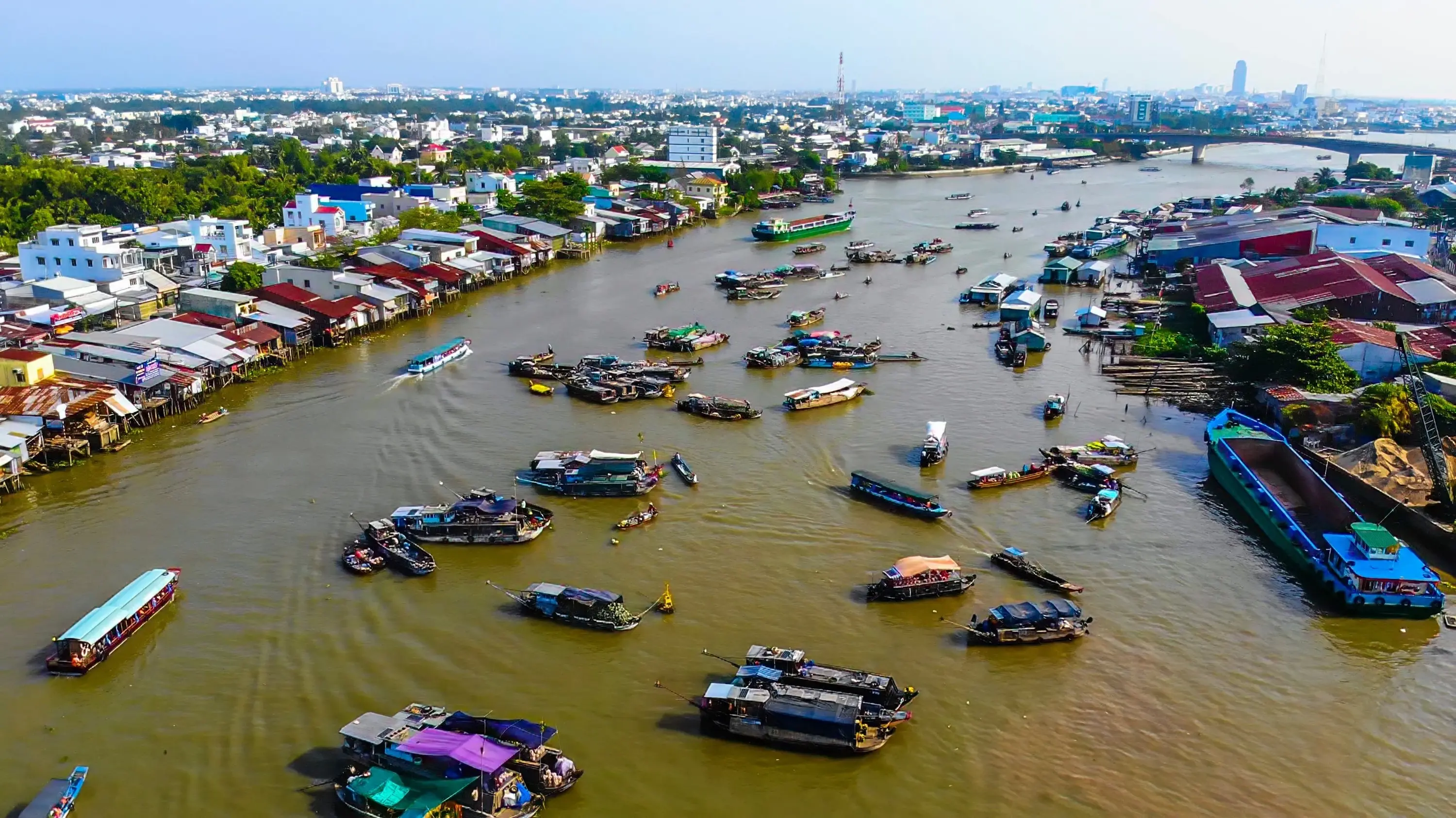 Aerial view of Can Tho's Cai Rang floating market on the Mekong River, with market and tourist boats in the foreground. Image credit: stock.adobe.com