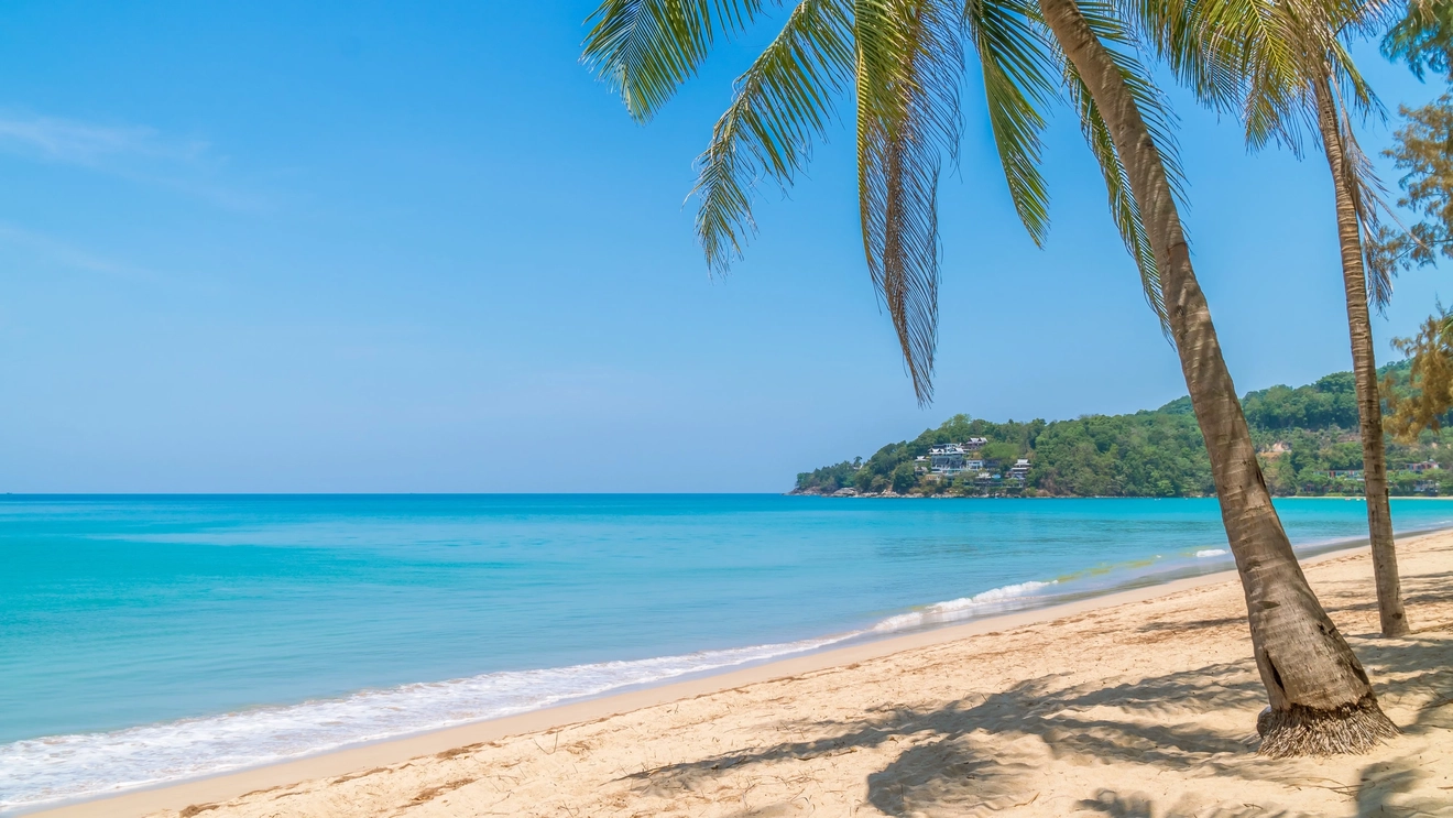 Kamala Beach with crystal clear water, white sand and palm trees, Phuket, Thailand.