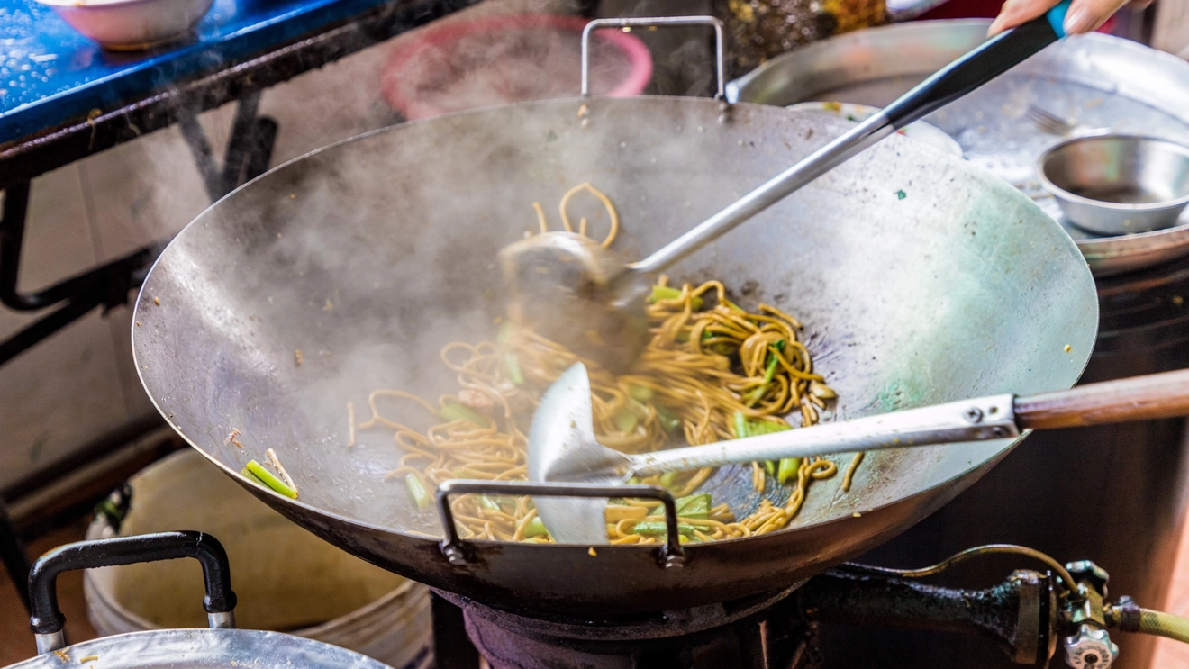 Close-up of a noodles being cooked in a wok, Phuket, Thailand. Image credit: stock.adobe.com