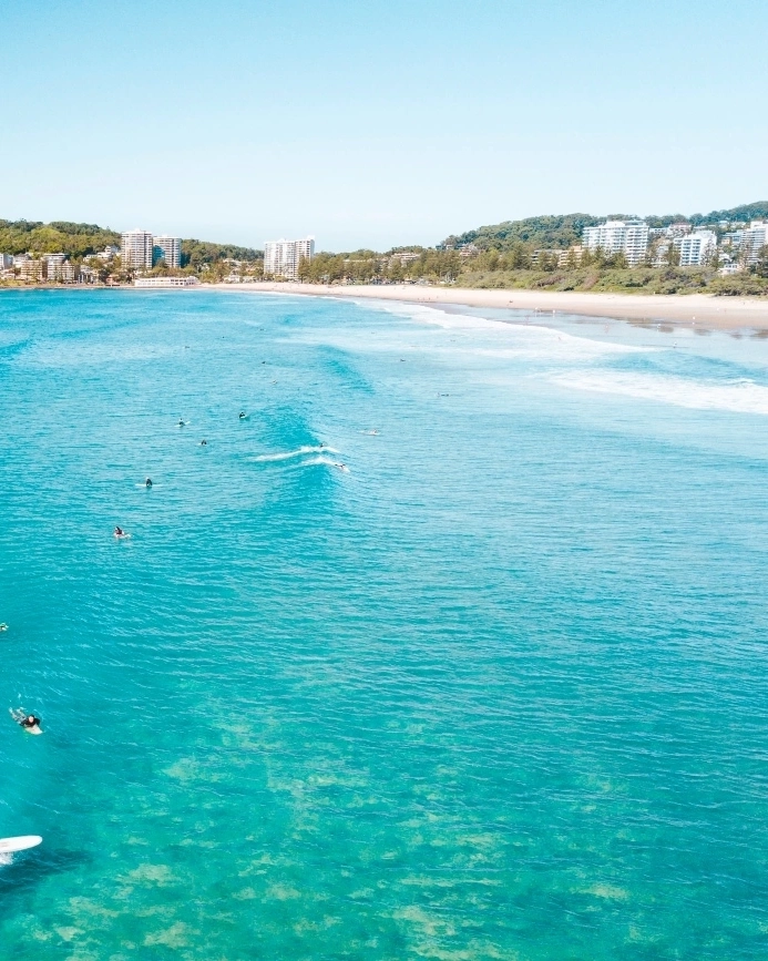 Aerial view of people surfing at North Burleigh, Gold Coast. Image credit: Tourism and Events Queensland.