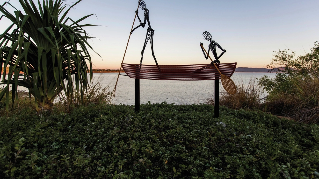 Aboriginal sculpture depicting two people in a canoe, Jezzine Barracks, Townsville. Image credit: Tourism and Events Queensland/Budd Photography