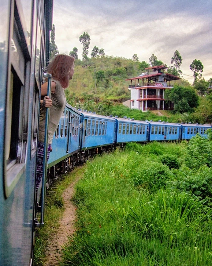 Woman peering out of train from Ella to Kandy