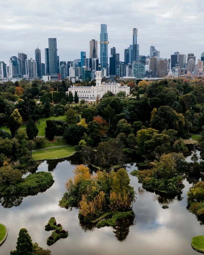 Aerial view of Melbourne's Royal Botanic Gardens and city skyline in the background. Image credit: Visit Victoria